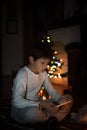 Boy watching tablet beside Christmas tree a Royalty Free Stock Photo