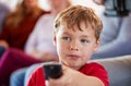 Boy Watching Television At Home With Multi-Generation Family Relaxing In Background Royalty Free Stock Photo