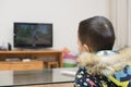 Chinese kid watching cartoon TV Royalty Free Stock Photo