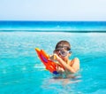 Boy with water gun squirt toy in the pool near sea Royalty Free Stock Photo