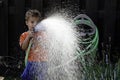 Boy with water hose Royalty Free Stock Photo