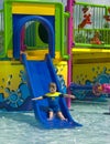 Boy on a water slide. Royalty Free Stock Photo