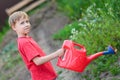 Boy watering garden Royalty Free Stock Photo