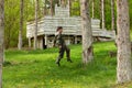Boy weared in camouflage playing laser tag in special forest playground Royalty Free Stock Photo