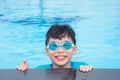 Boy wearing blue goggles and smiling in pool Royalty Free Stock Photo