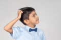 The boy wearing blue shirt with tie-bow thinking about someth Royalty Free Stock Photo