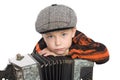 Boy wearing a cap with accordion. Royalty Free Stock Photo