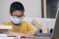 Boy wearing face masks online study at home