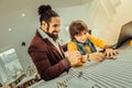 Boy wearing glasses feeling involved in working in atelier Royalty Free Stock Photo