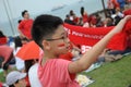 A boy holding a red inspirational towel during a gathering at the Marina Barrage Roof Garden in Singapore