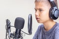 Boy wearing headphones talks using microphone set Online learning, remote education, gaming, podcast Royalty Free Stock Photo