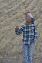 Boy wearing horse head mask