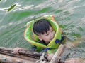 A boy wearing a life jacket to swim safely and enjoy Royalty Free Stock Photo