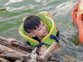 A boy wearing a life jacket to swim safely and enjoy