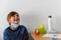 Boy wearing a medical mask smiling and laughing at school, new normal back to school during Covid-19