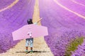 Boy wearing pilot costume plays in lavender field