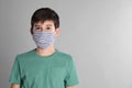 Boy wearing protective mask on light grey background, space for text. Child safety Royalty Free Stock Photo