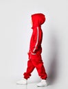 Boy wearing red warm jumpsuit posing for camera