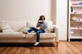 Boy wearing virtual reality goggles. Studio shot, white couch Royalty Free Stock Photo