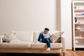 Boy wearing virtual reality goggles. Studio shot, white couch Royalty Free Stock Photo