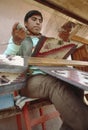 Boy weaving textiles in Cusco, Peru Royalty Free Stock Photo