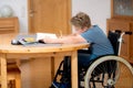 Boy in wheelchair doing homework Royalty Free Stock Photo