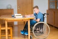 Boy in wheelchair doing homework Royalty Free Stock Photo