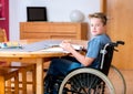 Boy in wheelchair doing homework Royalty Free Stock Photo