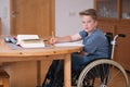 Boy in wheelchair doing homework Royalty Free Stock Photo