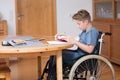 Boy in wheelchair doing homework Royalty Free Stock Photo