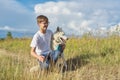 Boy with white dog, teenager walking with husky pet