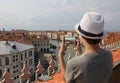 Boy with a white hat photographs the city of Venice Royalty Free Stock Photo