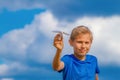 Boy with paper plane against blue sky Royalty Free Stock Photo