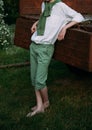 The boy is leaning on the old truck cousin, barefoot on the grass in the summer. Royalty Free Stock Photo