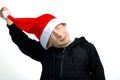 A boy who has a red Santa hat on his head, he takes it off Royalty Free Stock Photo