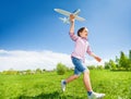 Boy who is holding airplane toy during running Royalty Free Stock Photo