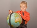 The boy who rotates the globe. Royalty Free Stock Photo