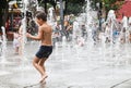 Boy who wallow in a fountain on a hot summer day Royalty Free Stock Photo