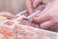 Boy wiht father building house from blocks and glue. Father with sun together play