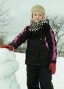 The boy is working diligently sculpts a snowman