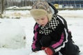 The boy is working diligently sculpts a snowman