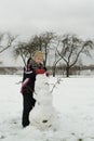 The boy is working diligently sculpts a snowman