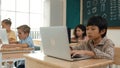 Boy working on his laptop while learning about coding prompt at class. Pedagogy. Royalty Free Stock Photo