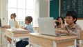 Boy working on his laptop while learning about coding prompt at class. Pedagogy. Royalty Free Stock Photo