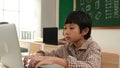 Boy working on his laptop while learning about coding prompt at class. Pedagogy. Royalty Free Stock Photo