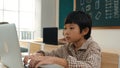 Boy working on his laptop while learning about coding prompt at class. Pedagogy. Royalty Free Stock Photo