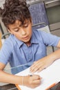 BOY WORKS AT HOME DURING CONTAINMENT PERIOD Royalty Free Stock Photo