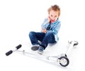 Boy with wounded ell near his scooter Royalty Free Stock Photo