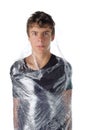 Boy wrapped in shrinkwrap cellophane Royalty Free Stock Photo