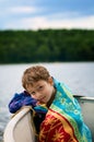 Boy wrapped in a towel in a boat Royalty Free Stock Photo